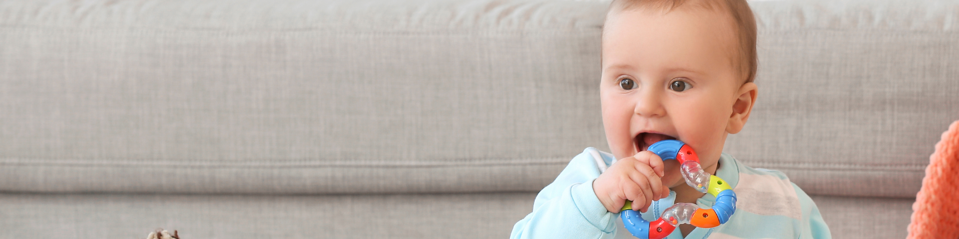 A baby playing with a teething toy