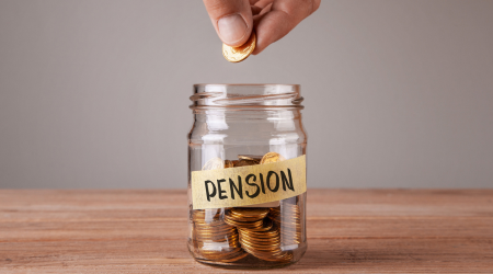 A hand putting a coin into a jar labelled "pension".