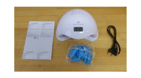BEAUTYLUSHH UV nail lamp on the eBay Platform Image Shows BEAUTYLUSHH UV nail lamp, with product instruction leaflet to the left, a cable to the right and a bag of small blue parts in front.