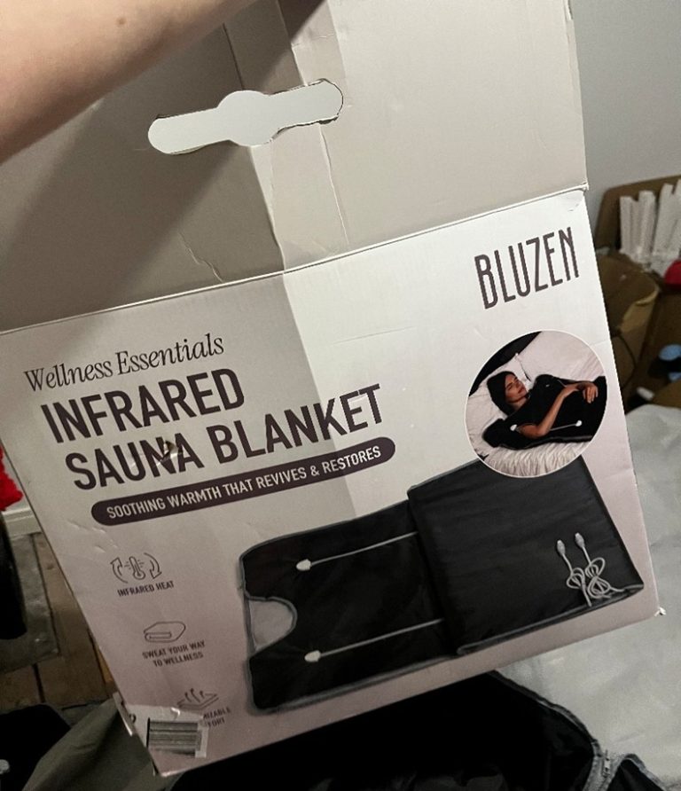 Bluzen Infrared Sauna Blanket Image shows cardboard box with the words 'Infrared Sauna Blanket', and 'Bluzen' in the corner written on it and a picture of a black sauna blanket.