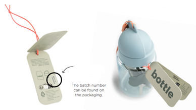 donebydeer3 Two objects shown side‑by‑side: on the left, a close‑up of product tags attached with an orange string, highlighting where the batch number is located on the packaging; on the right, a light blue children's water bottle with product tags attached to the lid.