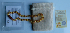 Product Safety Information Notice on an Amber teething necklace sold on the AliExpress platform