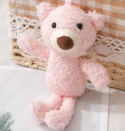 Soft-Toy-Pale-Pink-Teddy A pale pink teddy with small black eyes and a large brown nose.