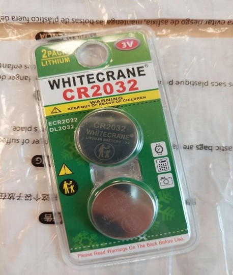 WHITECRANE-Button-Batteries Two button batteries in green package with Whitecrane CR2032 at the top of the package